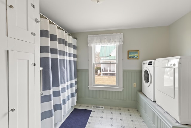 10 Leeman Hill Rd, Bristol, ME 04554 - clothes washing area featuring washing machine and clothes dryer, a wainscoted wall, tile patterned floors, and baseboards