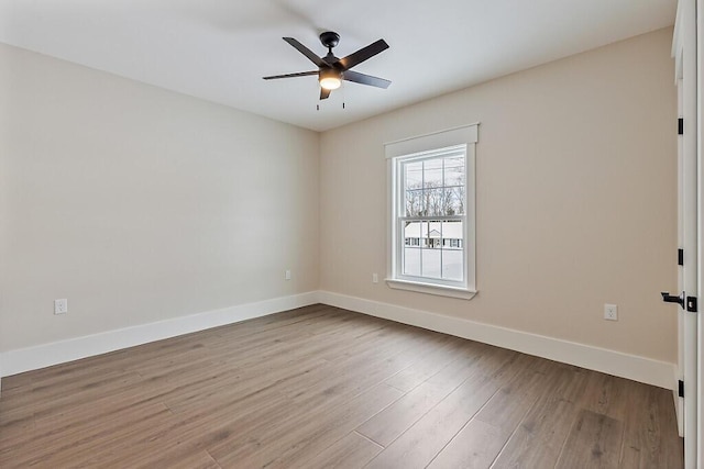 spare room with light hardwood / wood-style flooring and ceiling fan