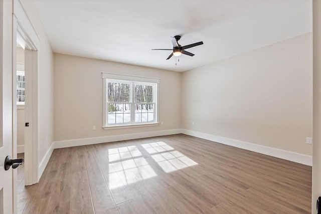 spare room featuring light hardwood / wood-style flooring and ceiling fan