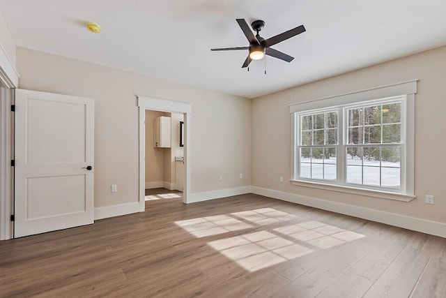 unfurnished room with hardwood / wood-style flooring and ceiling fan