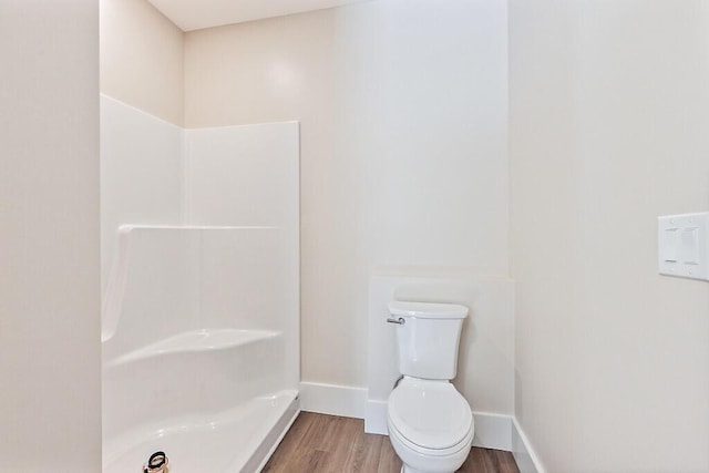 bathroom with hardwood / wood-style flooring and toilet