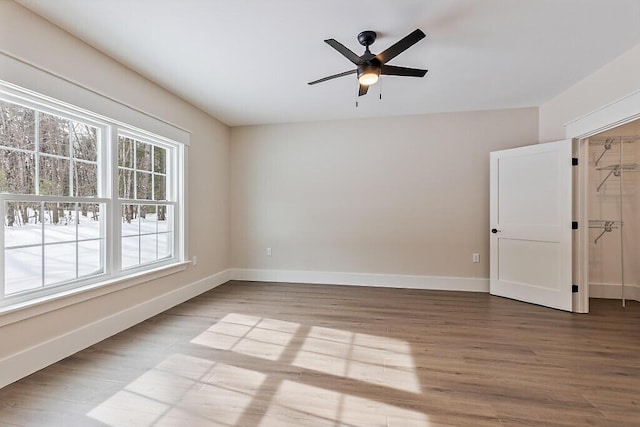 spare room featuring ceiling fan and hardwood / wood-style floors