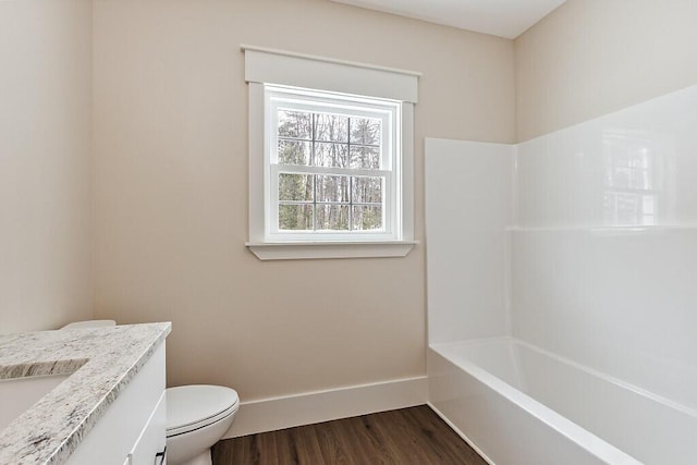 full bathroom featuring toilet, hardwood / wood-style flooring, vanity, and tub / shower combination