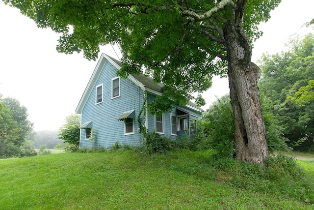 view of side of home featuring a lawn