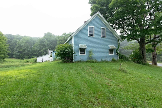 view of side of property with a lawn