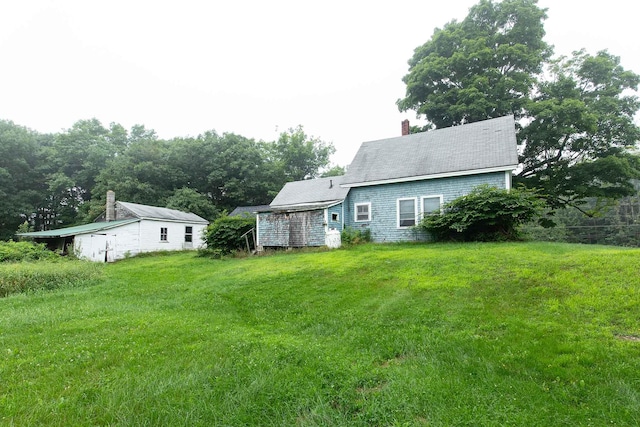 rear view of house featuring a lawn