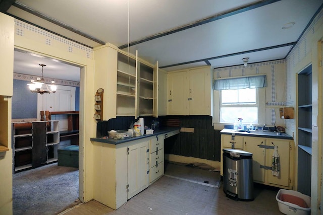 kitchen with sink, a chandelier, and pendant lighting