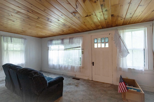 living room featuring plenty of natural light, carpet, and wooden ceiling