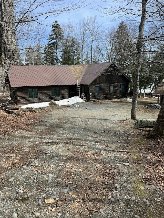 45 Dickson Rd, Carrying Place Town Twp, ME 04961 - view of front of home featuring driveway, metal roof, and log exterior