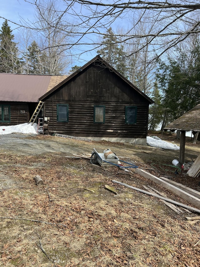 45 Dickson Rd, Carrying Place Town Twp, ME 04961 - view of side of home with log exterior