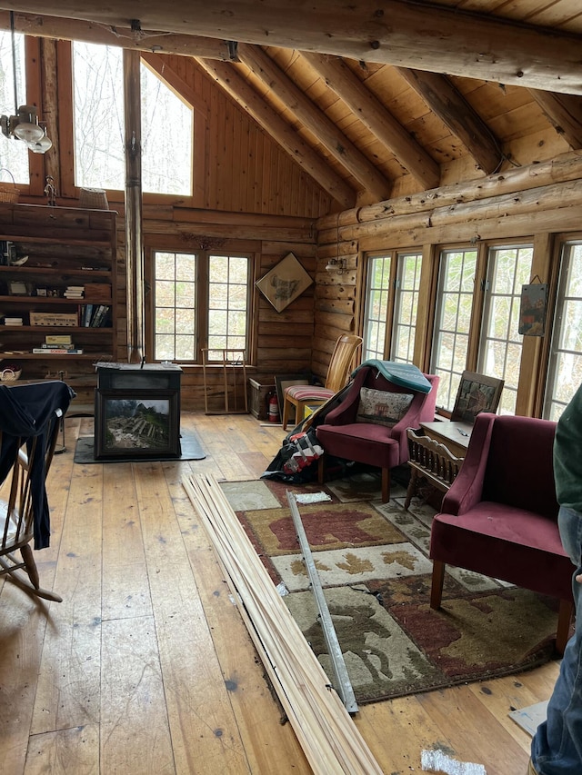 45 Dickson Rd, Carrying Place Town Twp, ME 04961 - living room with lofted ceiling with beams, wood-type flooring, log walls, and plenty of natural light
