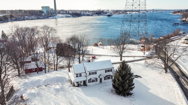 snowy aerial view featuring a water view