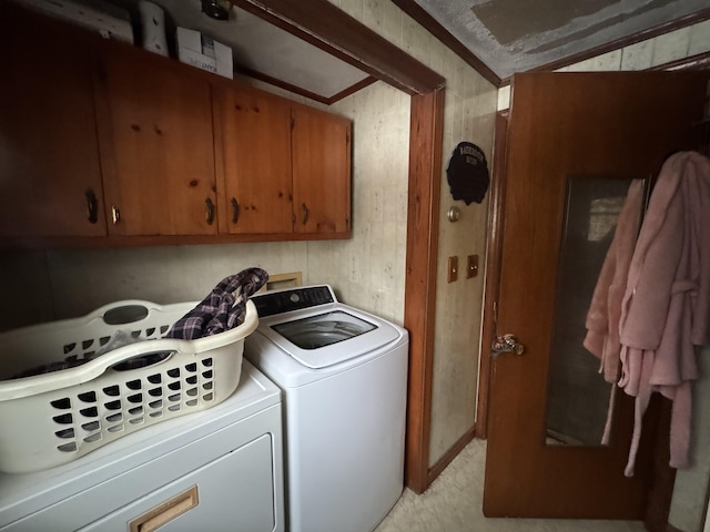 washroom featuring cabinet space and washing machine and dryer