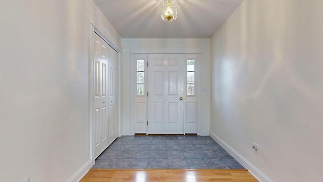 entryway with wood finished floors and baseboards