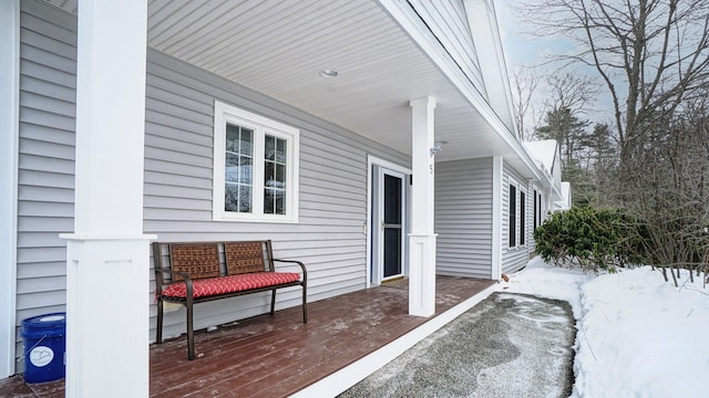 snow covered patio featuring a porch