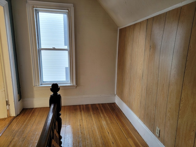bonus room with wood-type flooring, baseboards, and lofted ceiling