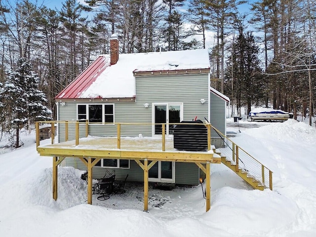 snow covered property featuring a wooden deck