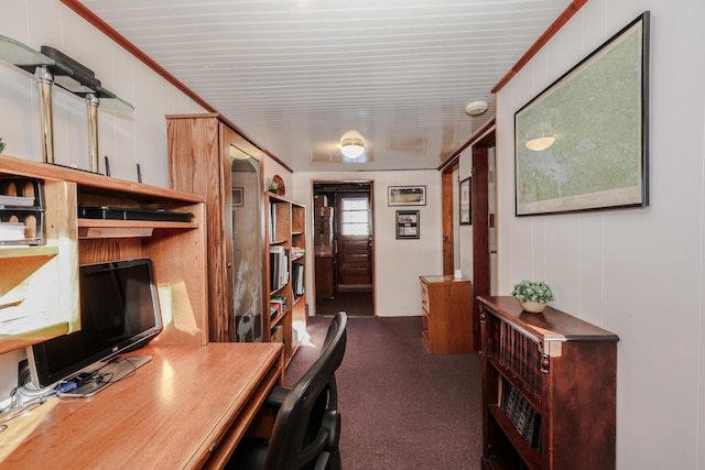 carpeted home office featuring crown molding