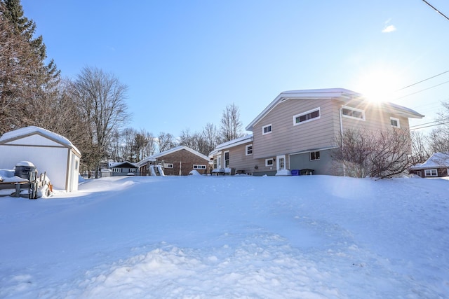 yard layered in snow with a garage