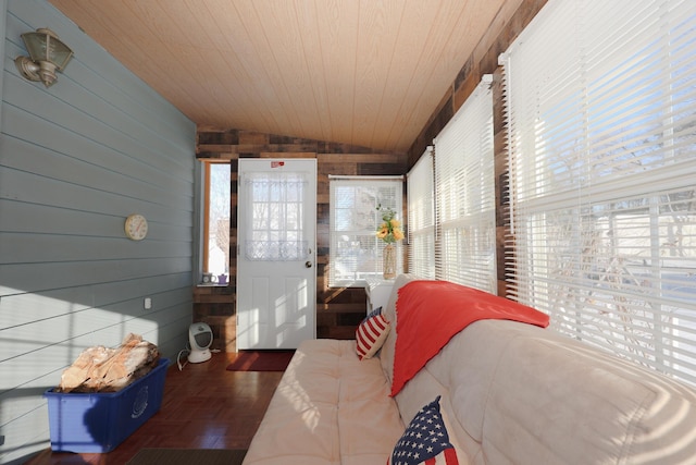 sunroom / solarium featuring plenty of natural light, wood ceiling, and lofted ceiling