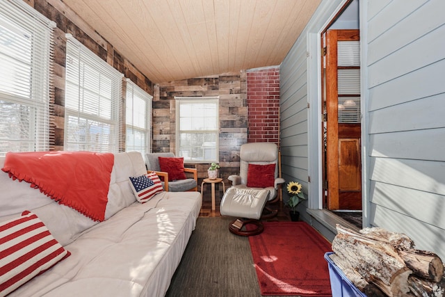 living room with wooden walls, vaulted ceiling, and wooden ceiling