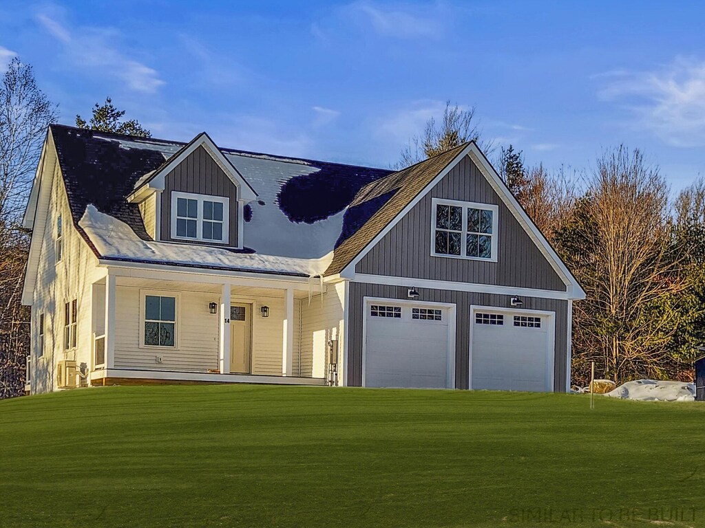 view of front facade with a garage, a front lawn, and a porch
