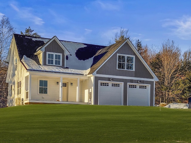 view of front facade with a garage, a front lawn, and a porch