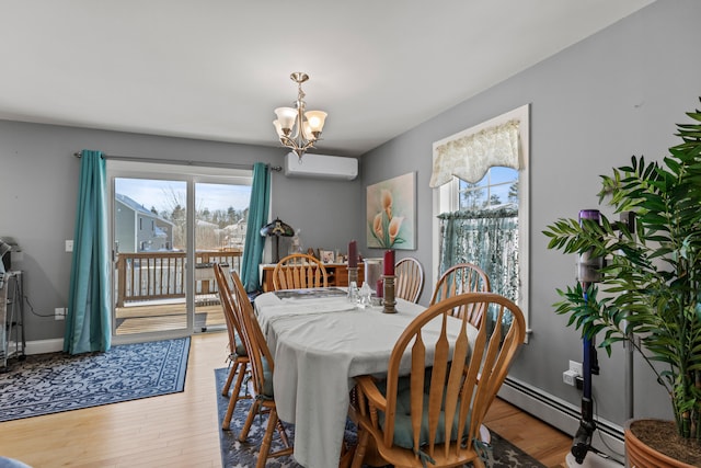 dining space with light wood-type flooring, a wall mounted AC, a chandelier, and a baseboard radiator