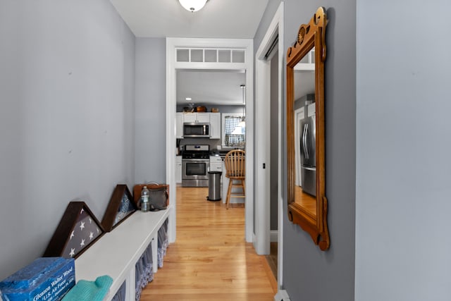 hallway with light hardwood / wood-style flooring