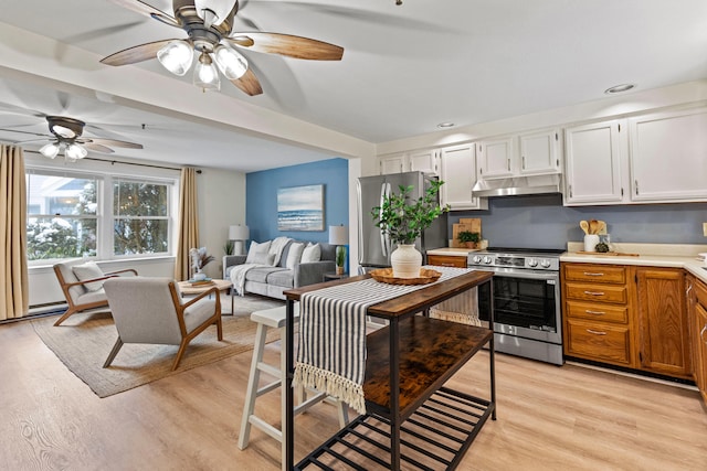 kitchen with appliances with stainless steel finishes, ceiling fan, light wood-type flooring, and white cabinets