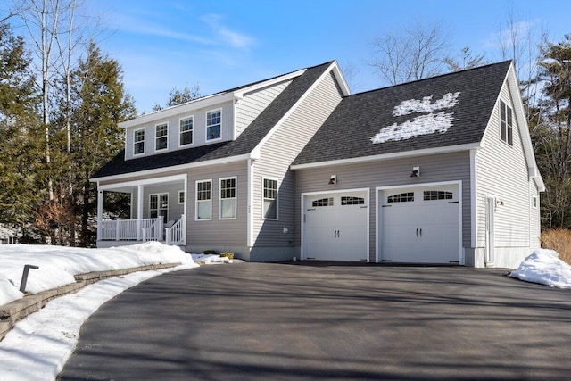 view of front facade with driveway, roof with shingles, a porch, and an attached garage