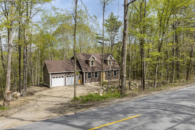 232 Bond Spring Rd, Newfield, ME 04095 - view of front of home featuring a garage, driveway, a wooded view, and a shingled roof