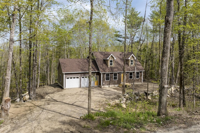 232 Bond Spring Rd, Newfield, ME 04095 - view of front of property featuring a garage, asphalt driveway, a forest view, and a shingled roof