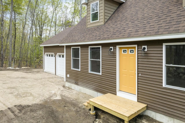 232 Bond Spring Rd, Newfield, ME 04095 - doorway to property featuring roof with shingles, a garage, and concrete driveway
