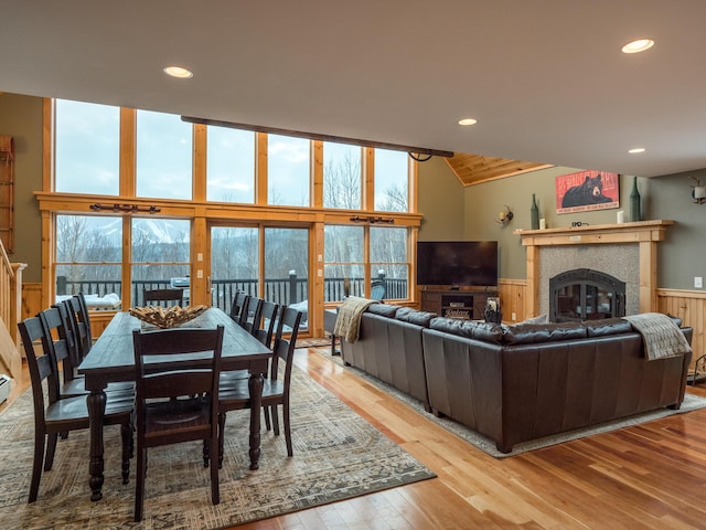 living room with light hardwood / wood-style floors, expansive windows, and a fireplace