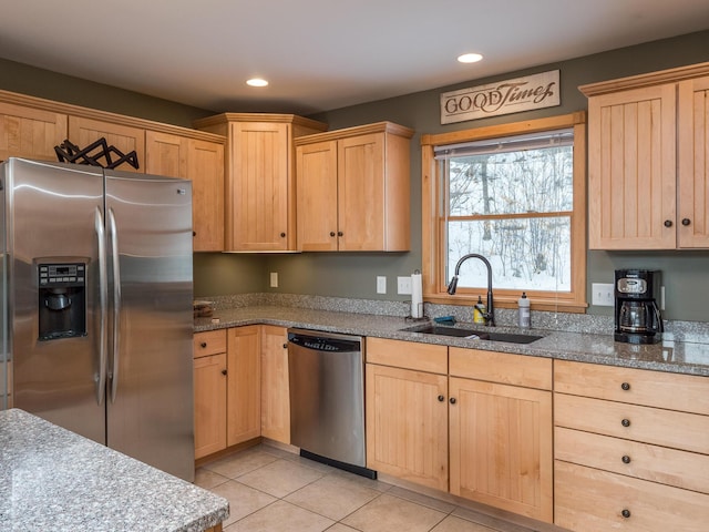 kitchen featuring appliances with stainless steel finishes, light tile patterned floors, sink, and light brown cabinets