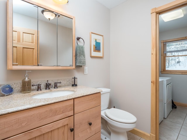 bathroom featuring vanity, separate washer and dryer, tile patterned flooring, and toilet