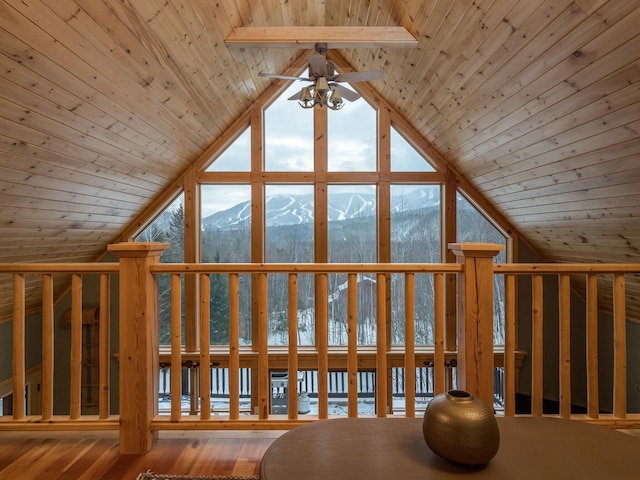 additional living space featuring vaulted ceiling, ceiling fan, wood ceiling, and a mountain view