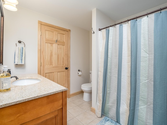 bathroom featuring tile patterned floors, vanity, and toilet