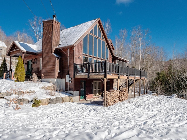 snow covered house with a deck