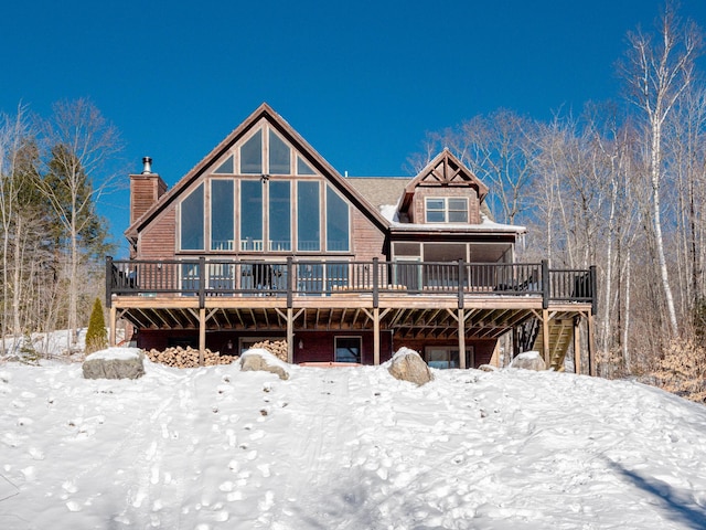 snow covered house featuring a deck