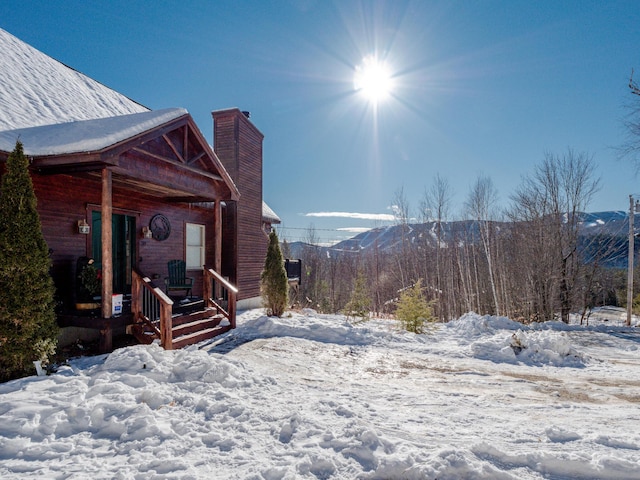 snowy yard with a mountain view