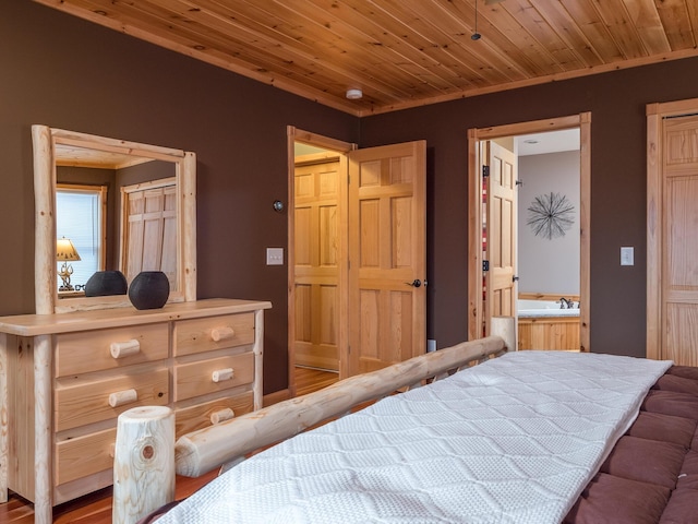 bedroom with connected bathroom and wooden ceiling