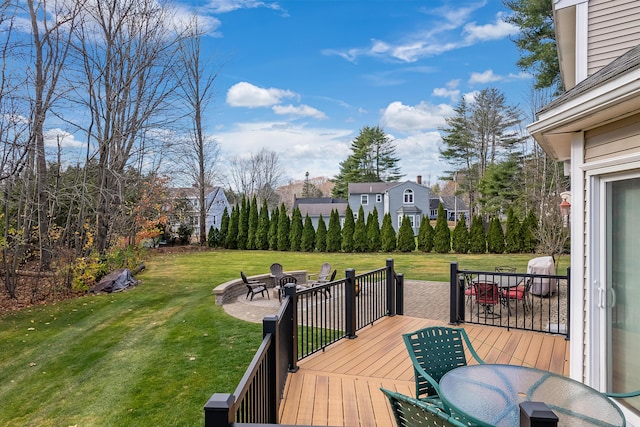 deck featuring a yard, an outdoor fire pit, and outdoor dining space