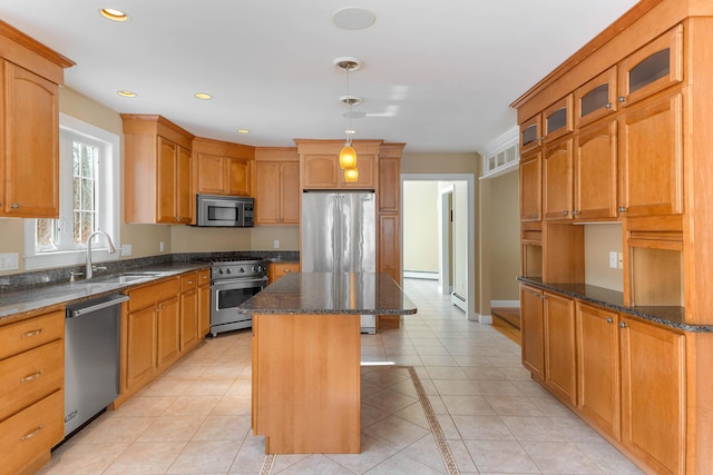 kitchen with visible vents, premium appliances, a kitchen island, glass insert cabinets, and a sink