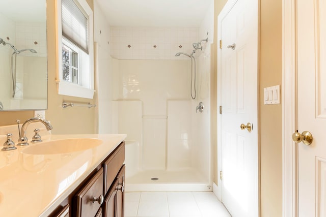 full bathroom featuring a stall shower, tile patterned flooring, and vanity