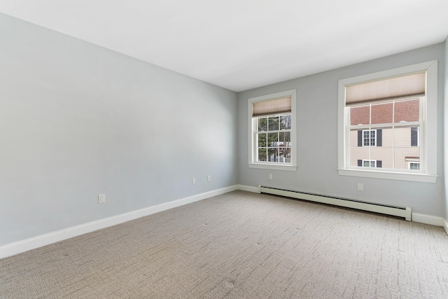 empty room with carpet, a baseboard radiator, and baseboards