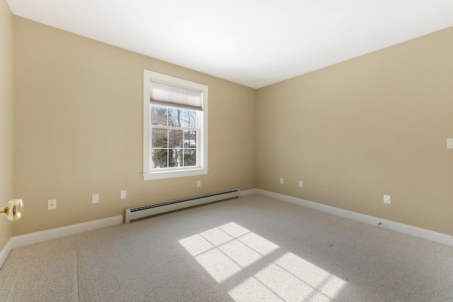 empty room featuring baseboard heating, carpet, and baseboards