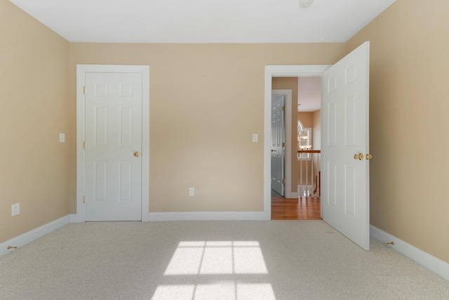 unfurnished bedroom with carpet floors and baseboards