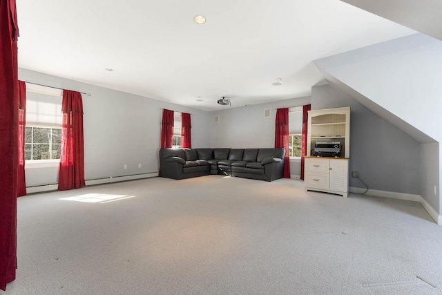 unfurnished living room with light carpet, baseboards, and baseboard heating